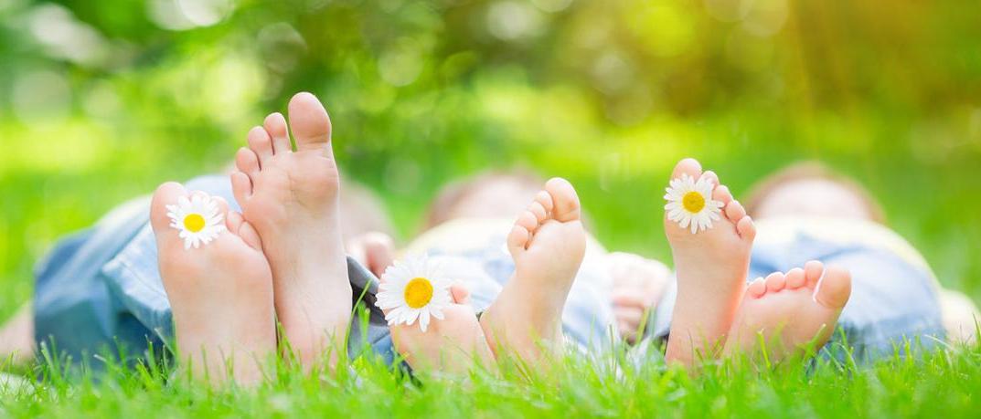 Feet in the grass on a sunny day